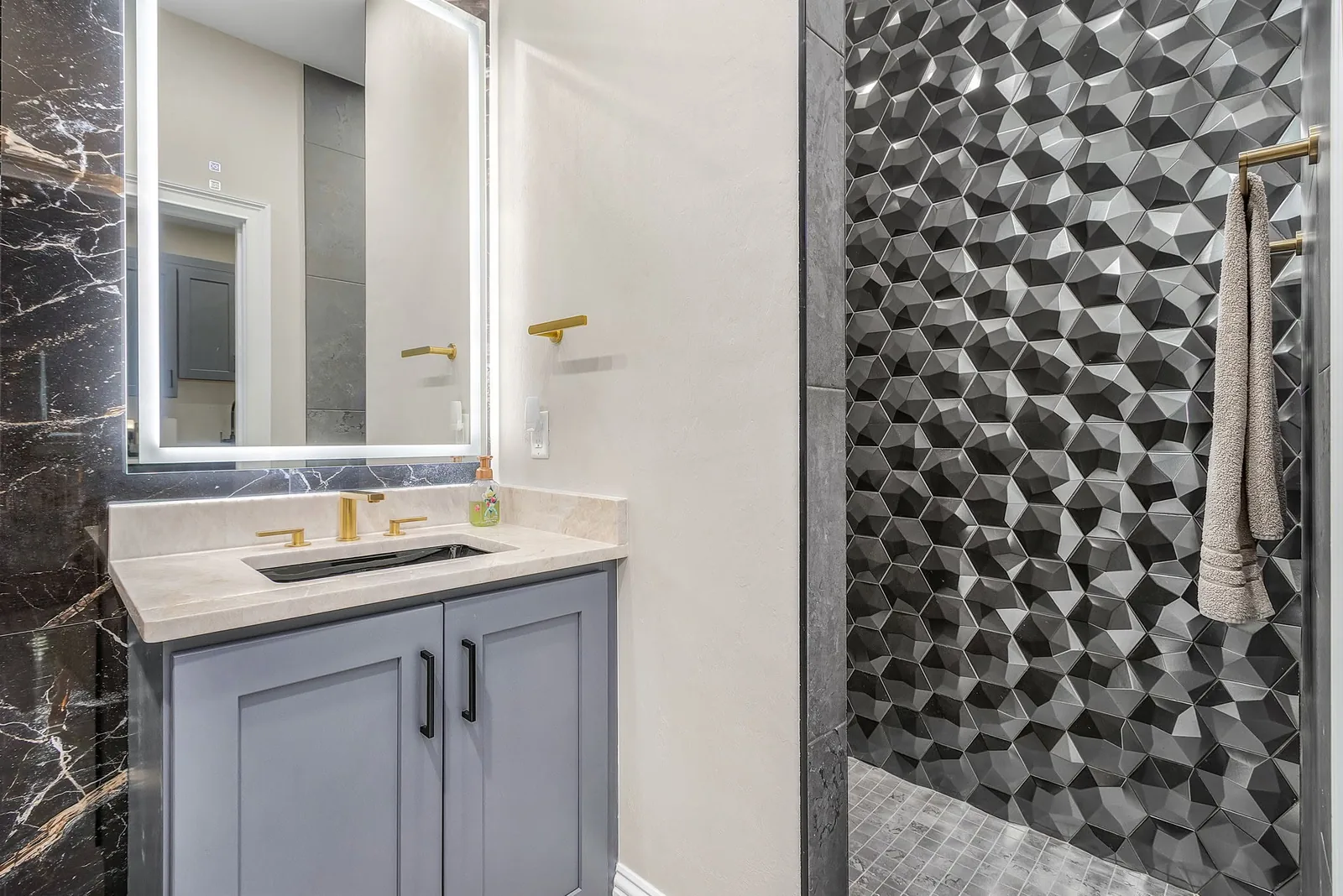 Completed Proskillz bathroom with a floating vanity, basin and geometric tile