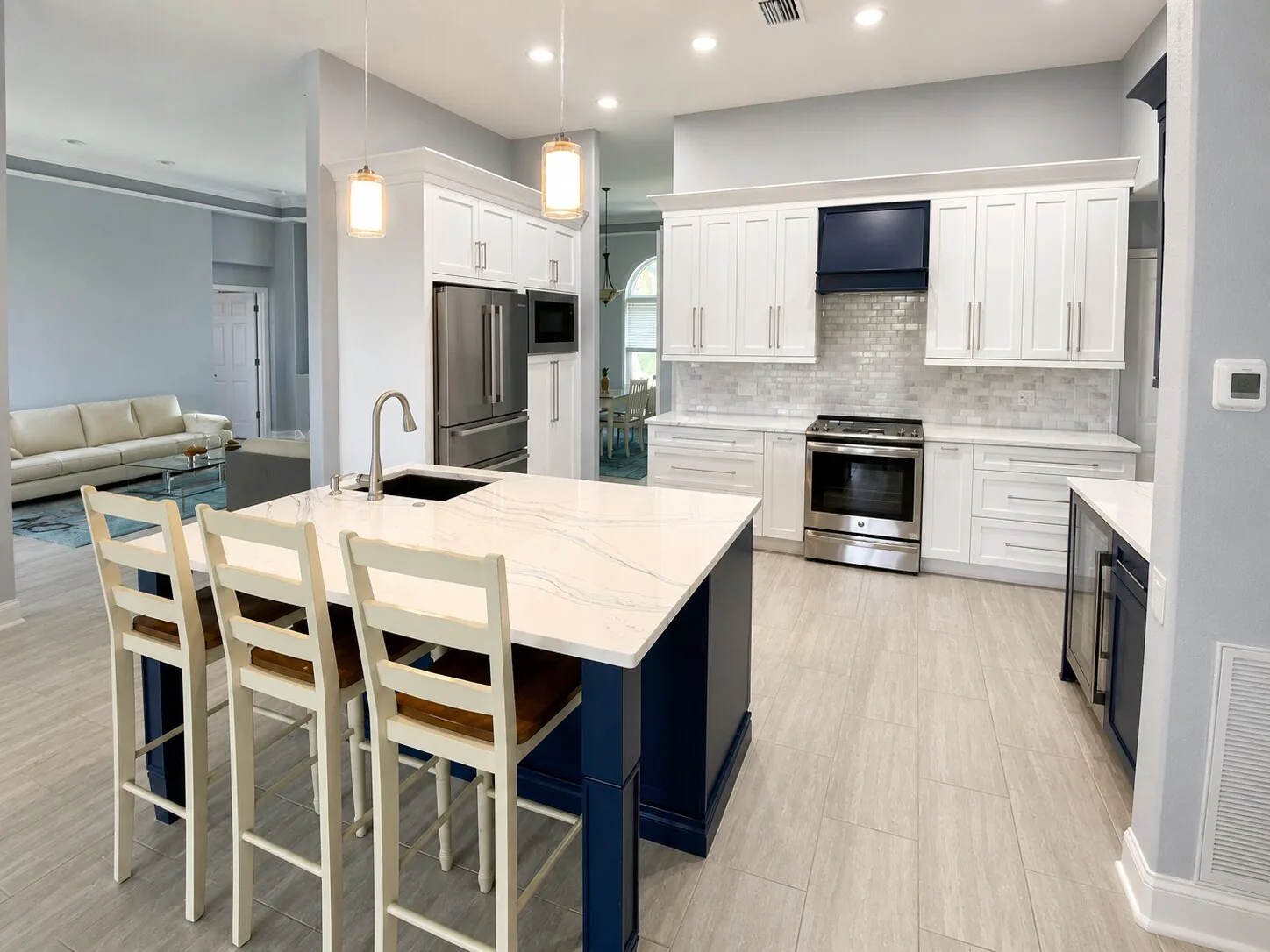 Completed Proskillz kitchen with continuous flooring around a navy island