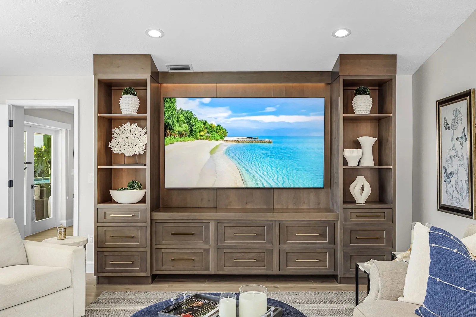 Completed living-space renovation with an integrated media wall by Proskillz Remodeling