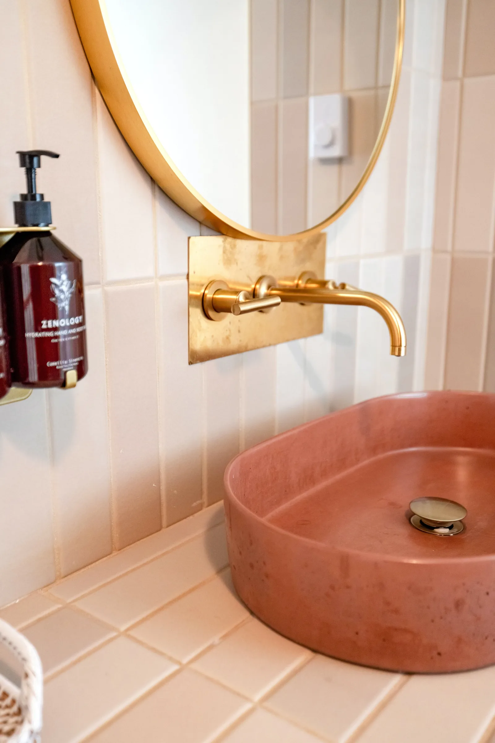 Design inspiration: wall-mounted gold faucet above a terracotta vessel sink