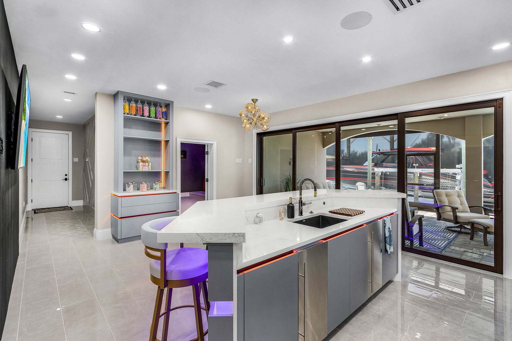 Completed home entertaining space with coordinated lighting and stone surfaces by Proskillz Remodeling