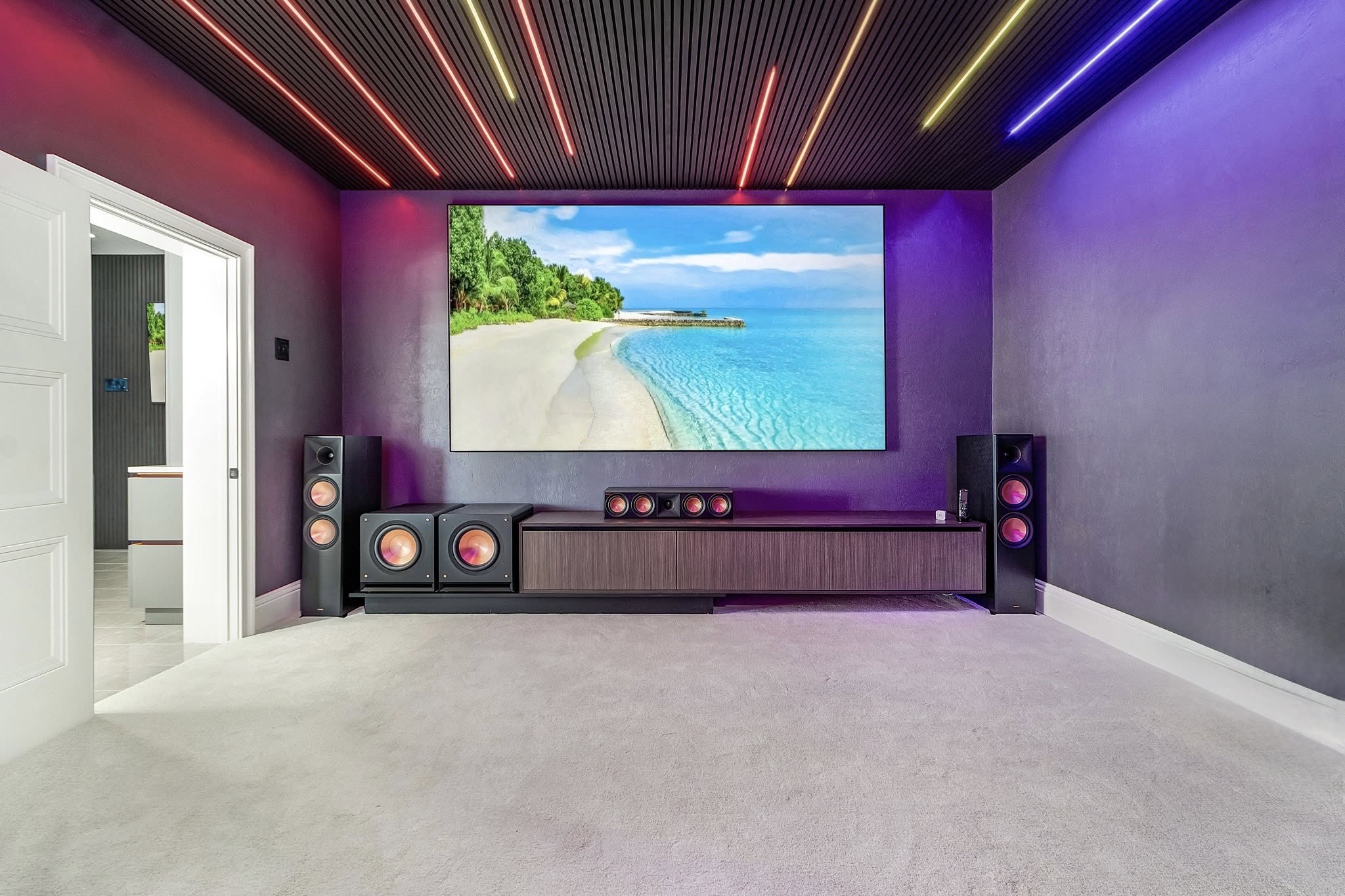 Completed theater space showing the screen wall, lighting and finish package by Proskillz Remodeling