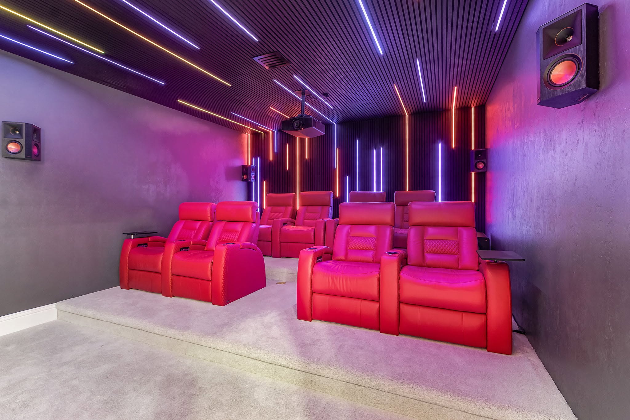 Completed home theater renovation with tiered seating and integrated lighting by Proskillz Remodeling